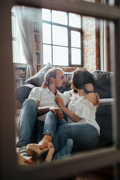 Portrait of beautiful and lovely couple relaxing at home - Photo, Image