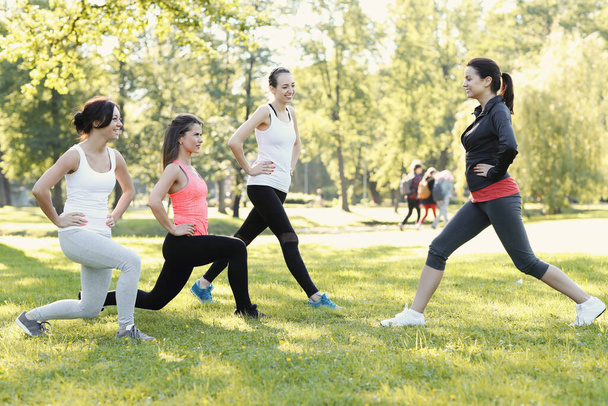 Sport. Women exercise in the park - Фото, изображение