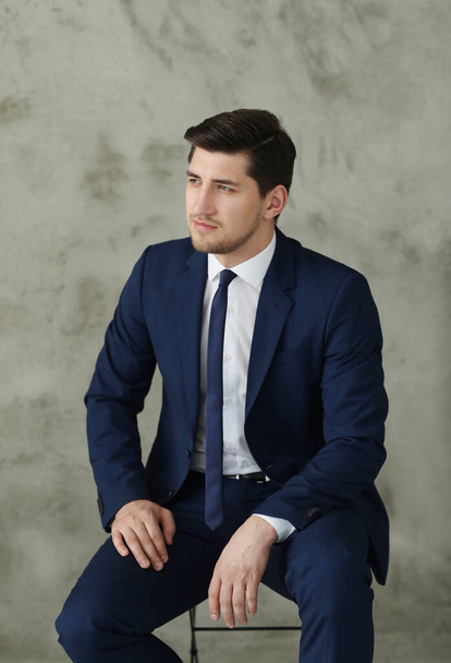 Young businessman in blue suit posing at home - Fotoğraf, Görsel