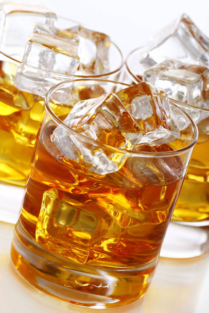 Glasses of cold whiskey with ice isolated over white - Photo, Image