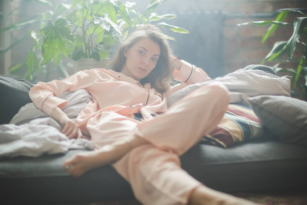 Morning leisure. Woman is lying on the bed - Valokuva, kuva