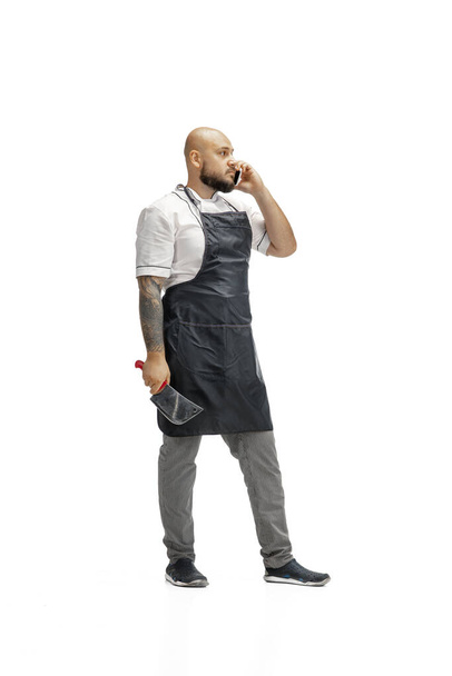 Portrait of a male chef cook, butcher isolated on a white studio background - Foto, afbeelding