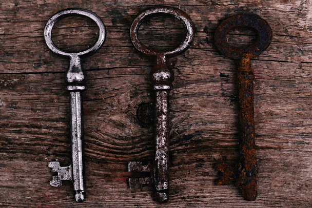 Old, rustic keys on the table - Photo, Image