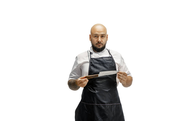 Portrait of a male chef cook, butcher isolated on a white studio background - Fotó, kép