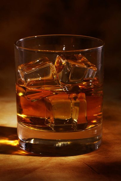 Koude whisky tegen oude achtergrond - Foto, afbeelding