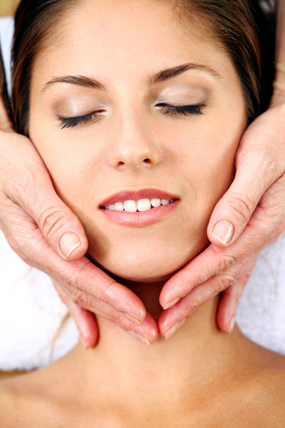 Young and beautiful woman getting face massage - Photo, Image