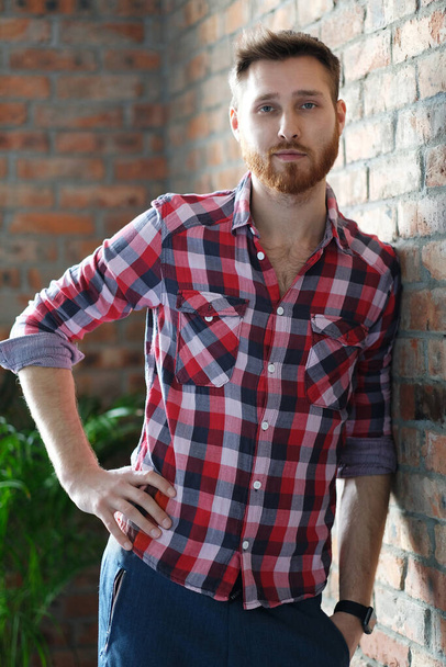 Portrait of young handsome man in plaid shirt - Foto, imagen