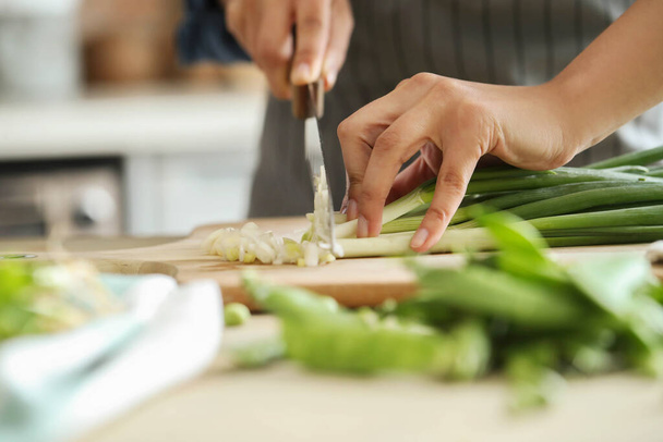Cooking. Chef is cutting greens in the kitchen - Foto, Imagem