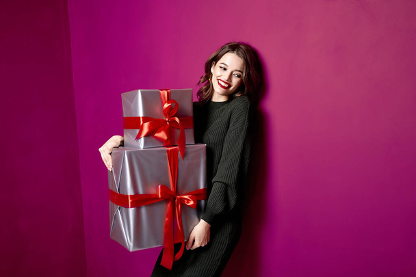 Beautiful sexy young brunette girl with wavy hair bright evening make-up red lips long fluffy eyelashes hold gift box holiday New Year  joy fun happy merry Christmas Eve party celebration St. Valentine's Day. - Foto, immagini
