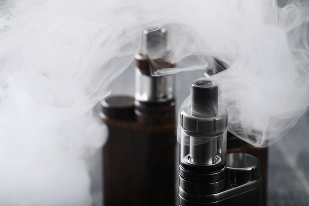 Vaping device on the wooden table - 写真・画像