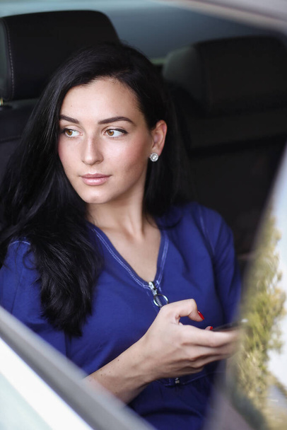 Businesswoman in car as a passanger - Photo, Image