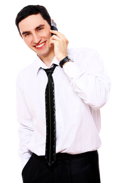 Young smiling businessman using cell phone isolated on white - Фото, изображение