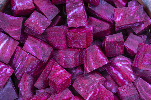 Fresh segments of a red beetroot, close up. Purple beet slices background, top view - Φωτογραφία, εικόνα