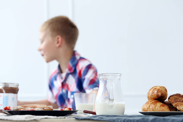 Breakfast. Young kid by the table - Fotoğraf, Görsel