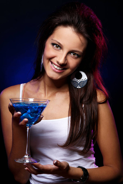 Young and beautiful woman with a blue cocktail in the nightclub - Zdjęcie, obraz