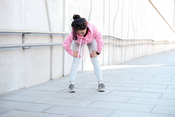 Street sport. Woman is exercising outdoor - Фото, зображення