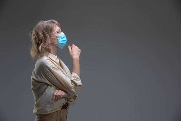 Blond young female in protective mask against viruses. - Foto, immagini