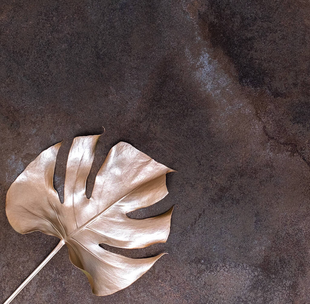 Golden palm leaf on the marble background. High quality photo. - Φωτογραφία, εικόνα