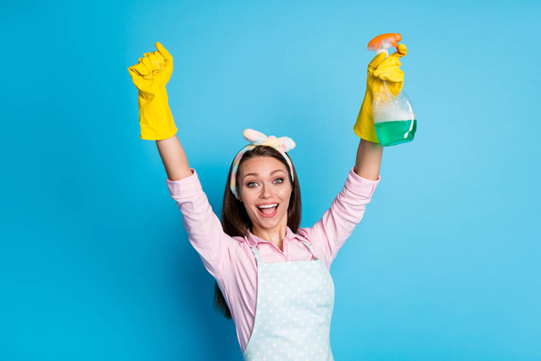 Portrait of her she nice attractive pretty cheerful cheery girl maid using chemical detergent rising hands up having fun isolated over bright vivid shine vibrant blue color background - Photo, image
