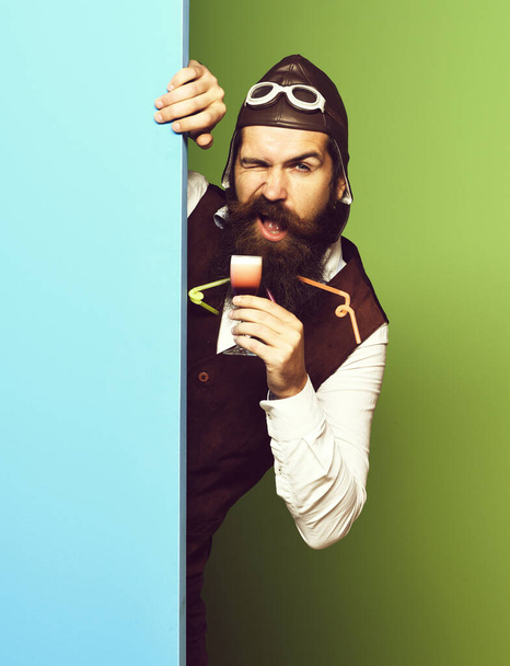 funny handsome bearded pilot on blue green studio background - Foto, immagini