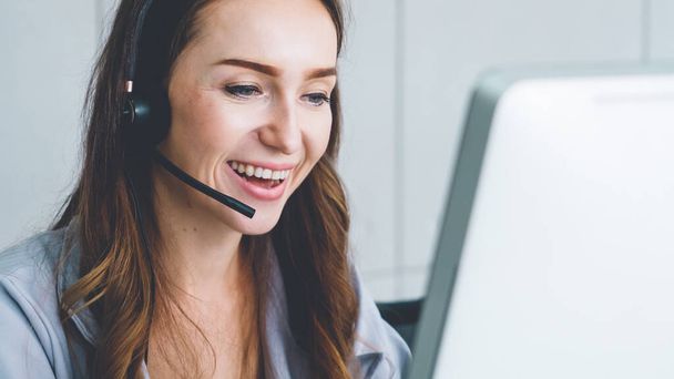 Business people wearing headset working in office to support remote customer or colleague. Call center, telemarketing, customer support agent provide service on telephone video conference call. - Foto, Bild