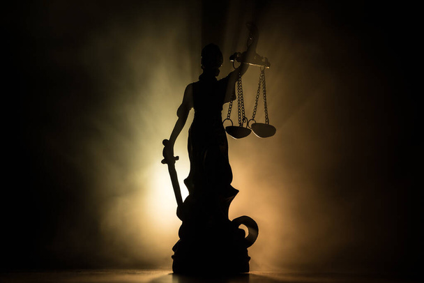 Law concept. Miniature colorful artwork decoration with fog and backlight. The Statue of Justice - lady justice or Iustitia / Justitia the Roman goddess of Justice. Selective focus - Photo, Image