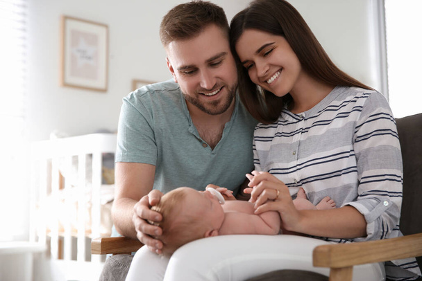 Happy couple with their newborn baby at home - Foto, Imagen