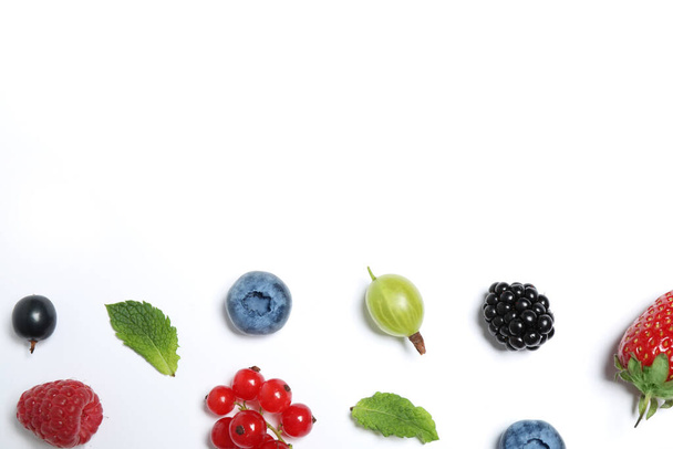 Mix of fresh berries on white background, flat lay. Space for text - Φωτογραφία, εικόνα
