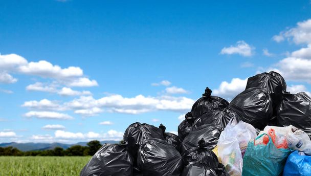 garbage bags large pile, plastic garbage waste big stack, lot of waste bag and sky background, copy space - Photo, Image
