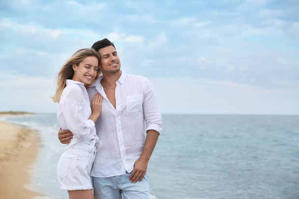 Happy couple on beach, space for text. Romantic walk - Fotografie, Obrázek