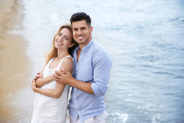 Happy couple on beach, space for text. Romantic walk - Fotografie, Obrázek