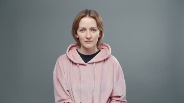 Shooting of young serene woman in pink sweatshirt - Footage, Video