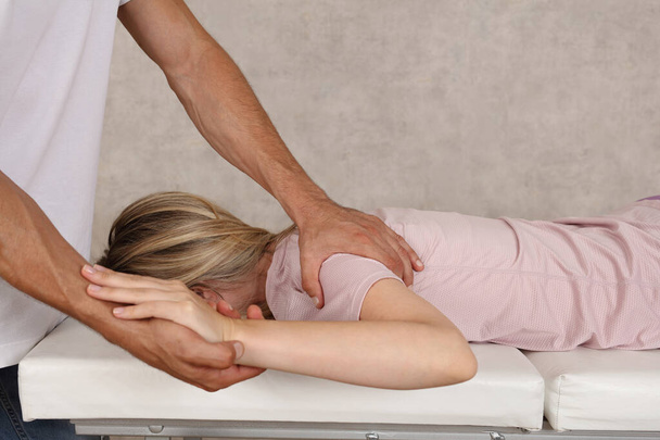 Shoulder joint mobilization by physiotherapist. Sport injury rehabilitation concept - Zdjęcie, obraz