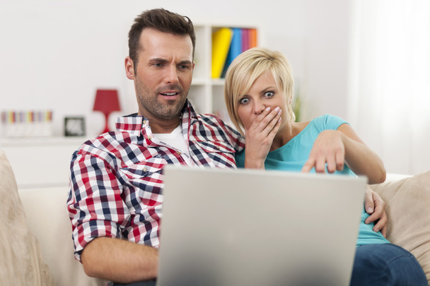 Shocked couple looking at laptop - Photo, Image