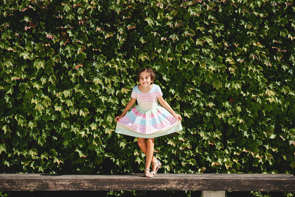 Menina feliz 9-year-old em um vestido bonito jogando - Foto, Imagem