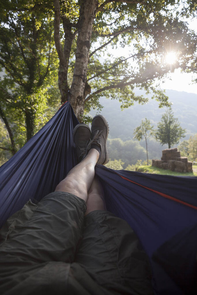 rest in a hammock between two trees - Фото, изображение
