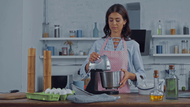 Femme utilisant un robot culinaire pendant la cuisson dans la cuisine  - Séquence, vidéo