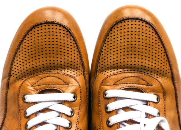 Brown sneakers on white background, brown shoes with white laces isolated - Photo, Image