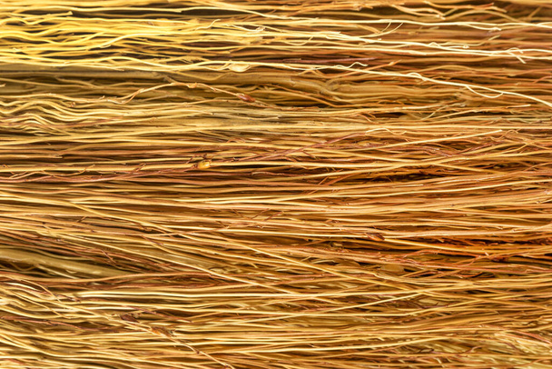 Пучок тонких сухих веток задний фон, куча желтых ветвей текстуры, закрытый полосатый веник, желтая хворост, старый сухой кустарник - Фото, изображение