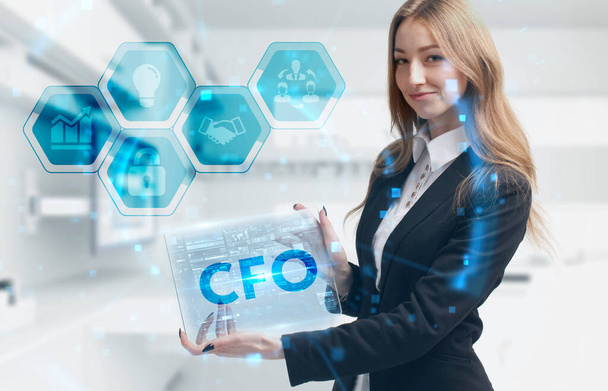 Business, Technology, Internet and network concept. Young businessman working on a virtual screen of the future and sees the inscription: CFO - Фото, зображення