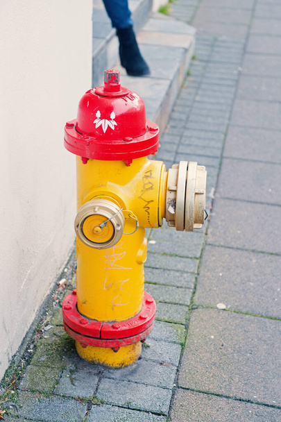 Yellow fire hydrant in street reykjavik iceland. Fire hydrant also called fireplug can tap into water supply. Active fire protection concept. Bright hydrant in grey street scandinavian country - Fotoğraf, Görsel