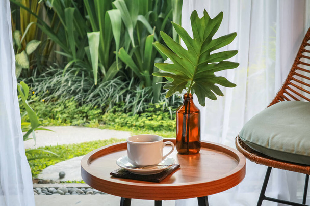 Beautiful tropical terrace or balcony with small table, chair and coffee - Φωτογραφία, εικόνα