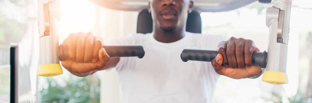 African American athlete doing exercise for chest muscles on pec deck machine during workout in gym - Φωτογραφία, εικόνα