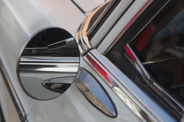 Κοντινό πλάνο της αριστερής πλευράς ενός παλιού αυτοκινήτου όπου ο καθρέφτης, μέρος της πόρτας του οδηγού και το παράθυρό του φαίνονται λεπτομερώς - Φωτογραφία, εικόνα
