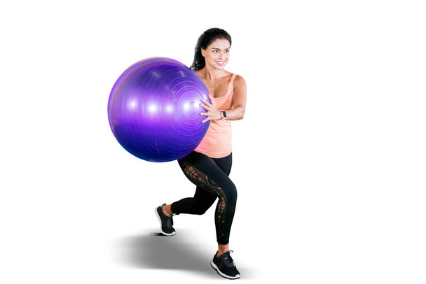 Curly hair woman wear sportswear while exercising with a yoga ball in the studio. Isolated on white background - Fotografie, Obrázek