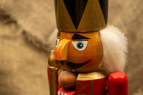 Nutcracker wooden figure of a soldier for cracking nuts. Traditional symbol of Christmas and New Year. Close up - Photo, Image