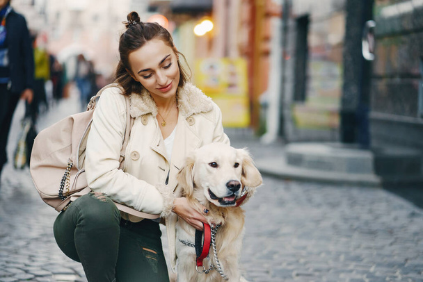 girl walking dog in the city - Photo, image