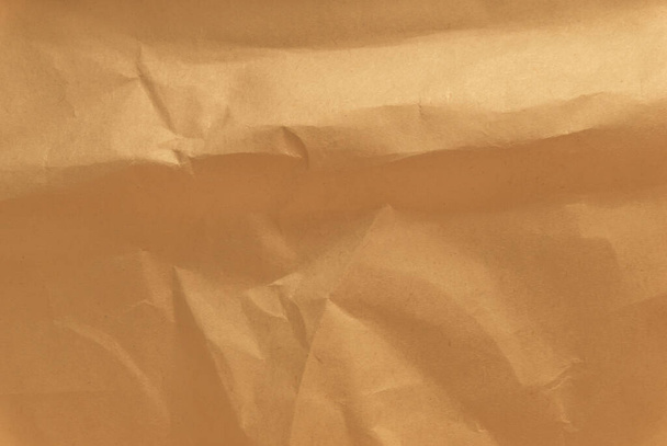 Papier d'emballage froissé brun, texture jaune ridée de vieux papiers vintage, plis sur la surface du papier - Photo, image