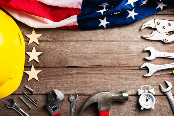 USA Labor day concept, Top view flat lay of different kinds wrenches with American flag on wood table. First Monday in September, creation of labor movement and dedicated to social of American worker - Photo, Image