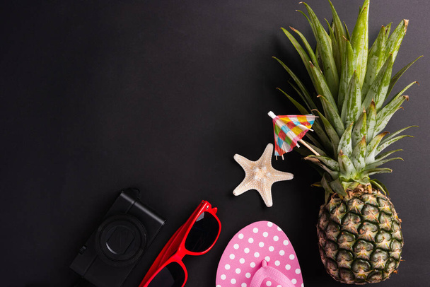 Celebrate Summer Pineapple Day Concept, Top view flat lay of funny fresh pineapple, sunglasses, starfish, slipper and camera, in studio isolated on blank background, Holiday summertime in tropical - Photo, Image
